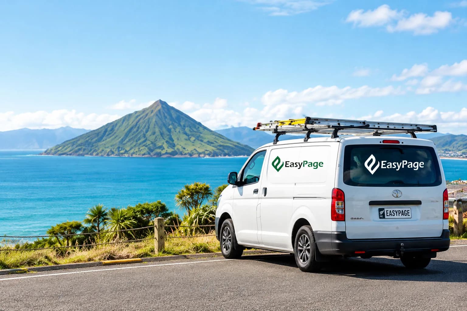 An EasyPage van parked on a coastal road in New Zealand, with a ladder on the roof rack.